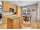 Kitchen with granite countertops, wood cabinets, an island, stainless steel appliances, and an eat-in breakfast area at 7138 Mountain Brush Cir, Highlands Ranch, CO 80130