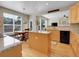 Well-lit kitchen featuring a center island, granite countertops, a breakfast nook, and hardwood flooring at 7138 Mountain Brush Cir, Highlands Ranch, CO 80130