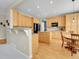 Spacious kitchen with stainless steel appliances, a large island, breakfast nook, and beautiful hardwood floors at 7138 Mountain Brush Cir, Highlands Ranch, CO 80130
