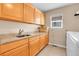 Functional laundry room with ample counter space and built-in cabinets at 7138 Mountain Brush Cir, Highlands Ranch, CO 80130