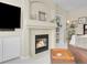Living room fireplace with a decorative mantel, built in shelving, and mounted television at 7138 Mountain Brush Cir, Highlands Ranch, CO 80130