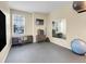 Spacious workout room with mirrored wall, fitness equipment, and natural light at 7138 Mountain Brush Cir, Highlands Ranch, CO 80130