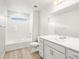 Bathroom with a tiled shower/tub, white cabinets and countertops, and a large mirror at 17487 E 89Th Way, Commerce City, CO 80022
