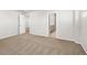 Spacious bedroom with neutral carpet and an open doorway into the bathroom at 17487 E 89Th Way, Commerce City, CO 80022