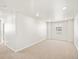 A carpeted room with a small window and recessed lighting at 17487 E 89Th Way, Commerce City, CO 80022