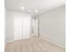 Bright bedroom featuring neutral carpet, white walls, and a closet with sliding doors at 17487 E 89Th Way, Commerce City, CO 80022