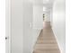 Bright hallway with wood floors leading to carpeted area and view to backyard at 17487 E 89Th Way, Commerce City, CO 80022