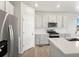 Modern kitchen boasts stainless appliances, granite countertops, and subway tile backsplash at 17487 E 89Th Way, Commerce City, CO 80022
