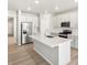 Bright kitchen with a large island, stainless steel appliances, and white cabinets at 17487 E 89Th Way, Commerce City, CO 80022