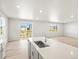 Spacious living area with luxury countertops, sink, and natural light at 17487 E 89Th Way, Commerce City, CO 80022