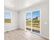 Bright living room featuring a large sliding glass door and nice outdoor views at 17487 E 89Th Way, Commerce City, CO 80022