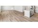 Open-concept living area with hardwood floors, island seating, and stainless appliances at 17487 E 89Th Way, Commerce City, CO 80022