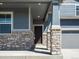 Inviting covered porch featuring stone columns, offering a warm welcome at 17487 E 89Th Way, Commerce City, CO 80022