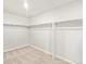 A clean, empty walk-in closet features carpet and shelving at 17487 E 89Th Way, Commerce City, CO 80022