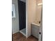 Modern bathroom features a tiled shower, wood-look flooring, and updated vanity at 20 E 45Th Ave, Denver, CO 80216