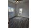 Spacious bedroom with gray carpet, lots of natural light, and a ceiling fan at 20 E 45Th Ave, Denver, CO 80216