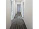 Hallway with multiple doors and new carpeting at 20 E 45Th Ave, Denver, CO 80216