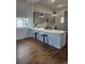 Spacious kitchen with white countertops, sleek gray cabinets, and modern bar stools, seamlessly blending style and functionality at 20 E 45Th Ave, Denver, CO 80216