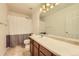 Bathroom showcasing a single sink vanity and shower with privacy curtain at 10168 Granby, Commerce City, CO 80022