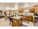 Open kitchen featuring an island with bar stool seating and a view of the dining area at 10168 Granby, Commerce City, CO 80022