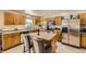 Well-lit kitchen with an island, stainless steel appliances, and plenty of cabinet space at 10168 Granby, Commerce City, CO 80022