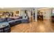 Spacious open-plan living room featuring gleaming hardwood floors and comfortable seating area at 10168 Granby, Commerce City, CO 80022