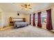 Large main bedroom featuring plush carpet, ceiling fan, and large windows for natural light at 10168 Granby, Commerce City, CO 80022