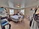 Simple bedroom features a bed, floral curtains, and storage, providing a comfortable personal space at 6060 Locust St, Commerce City, CO 80022