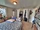 Bedroom with blue snowflake comforter, closet, and window with floral curtains at 6060 Locust St, Commerce City, CO 80022