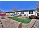 Quaint single-story home with solar panels, black shutters, and an easy-care gravel yard at 6060 Locust St, Commerce City, CO 80022
