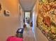 Narrow hallway features a striking tapestry adding a unique touch to the home's interior at 6060 Locust St, Commerce City, CO 80022