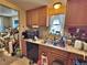 View of kitchen showcases wood cabinetry, a stainless steel sink, and a view into another room at 6060 Locust St, Commerce City, CO 80022