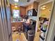 A kitchen that features classic wood cabinets, a black appliance suite, and tiled flooring at 6060 Locust St, Commerce City, CO 80022