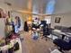 A living room with carpeted flooring, a comfortable sofa, and multiple furniture pieces at 6060 Locust St, Commerce City, CO 80022