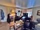 Cozy living room featuring carpeted floors, an entertainment center, and comfortable seating at 6060 Locust St, Commerce City, CO 80022