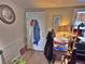 A detailed view of the living room entrance featuring carpeted floor and various decorations at 6060 Locust St, Commerce City, CO 80022