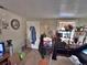 Cozy living room features carpeted floors, a collection of personal items and shelving for storage at 6060 Locust St, Commerce City, CO 80022