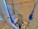 Accessible tiled shower featuring supportive grab bars and a convenient seat for comfortable bathing at 6060 Locust St, Commerce City, CO 80022