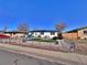 Cozy home with fenced gravel yard, offering a low-maintenance and inviting exterior at 6060 Locust St, Commerce City, CO 80022