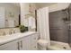 Well-lit bathroom with modern vanity, neutral wall tiles and walk-in shower at 539 Wright St # 102, Lakewood, CO 80228