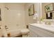 Bright bathroom with white tiled walls, toilet, shower and tub combination, and modern vanity at 539 Wright St # 102, Lakewood, CO 80228