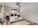 Cozy bedroom with a ceiling fan, warm wood-look floors, neutral walls, and natural light at 539 Wright St # 102, Lakewood, CO 80228