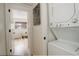 Hallway with a stacked washer and dryer and an open doorway to another room at 539 Wright St # 102, Lakewood, CO 80228