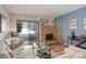 Comfortable living room featuring a stone fireplace, wood floors, and sliding glass doors to the outside at 539 Wright St # 102, Lakewood, CO 80228