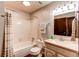 Functional bathroom features a tub, shower, toilet, vanity, and mirror in a clean design at 8538 W Glasgow Pl, Littleton, CO 80128