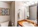 Powder bathroom with vanity, toilet, and attractive wall art at 8538 W Glasgow Pl, Littleton, CO 80128