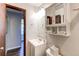This bathroom offers a sink with vanity, a mirrored medicine cabinet and a toilet at 8538 W Glasgow Pl, Littleton, CO 80128