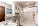 The bathroom features a glass enclosed shower, a sink with vanity and mirrored cabinet at 8538 W Glasgow Pl, Littleton, CO 80128