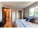 Comfortable bedroom featuring a closet and wood-look floors, with ample natural light at 8538 W Glasgow Pl, Littleton, CO 80128