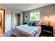 Bright bedroom with wood flooring, a closet and a large window with green views at 8538 W Glasgow Pl, Littleton, CO 80128
